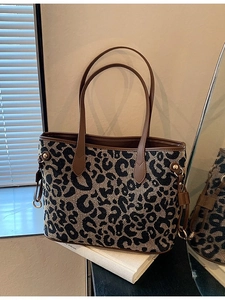 Chic leopard print tote bag with brown leather handles and side drawstring details