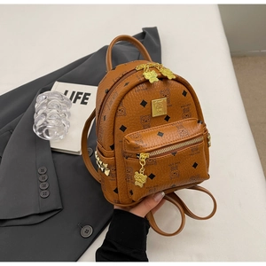 Detail shot of the brown leather mini backpack with bear motifs and gold studs