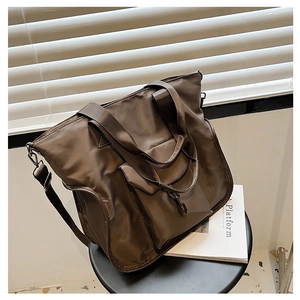 Brown nylon tote bag with adjustable shoulder strap and metal chain detail for women