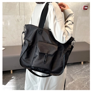 Black large capacity nylon tote bag with functional flap pocket and shoulder strap