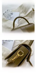 Detail of olive green leather bag featuring round top handle and gold hardware hooks
