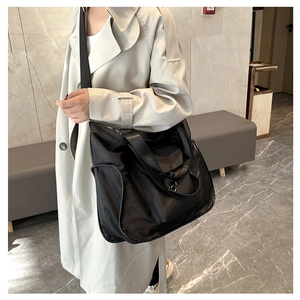 Detail of black nylon tote bag with wide adjustable shoulder strap and large capacity