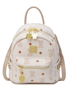 Mini beige backpack with brown cartoon bear prints and gold rivets on a white background