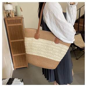 Close-up of contrast woven tote bag showing detailed texture and brown leather straps