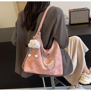 Pink quilted leather hobo bag featuring silver chain and pearl cloud charm on shoulder