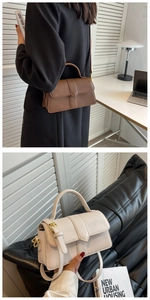 Detailed view of the sleek rectangular flap bag in dark coffee and cream leather