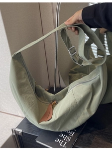 Large crescent nylon crossbody bag in sage green with adjustable wide shoulder strap