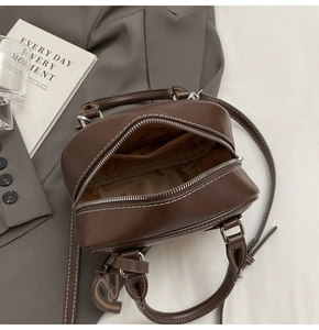 Detail view of the deep brown bowling bag interior showing lining and inner pocket