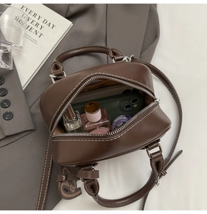 Interior view of the dark brown leather bowling bag showing ample space for phone and makeup