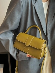 Olive green leather crossbody bag with top handle and geometric flap design for women