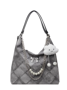 Quilted gray denim tote bag with silver bow and pearl chain strap on white background