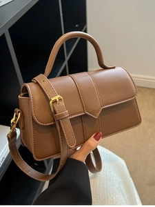 Classic brown matte leather crossbody bag with top handle and elegant vertical stitching