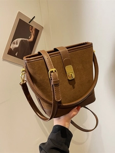 Vintage brown suede bucket bag with leather trim and gold metal twist lock closure