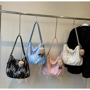 Detailed display of four quilted tote bags in black, blue, pink and beige with cute charms