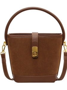 Retro brown suede bucket bag with leather trim and gold twist lock in a front view