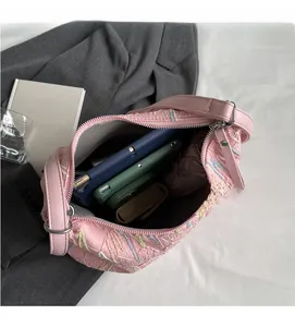 Spacious interior of pink quilted hobo bag holding a tablet, wallet and daily essentials