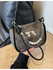 Gray washed denim shoulder bag with silver bow, pearl chain and black leather trim