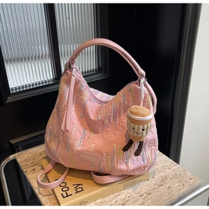 Pink pleated leather shoulder bag with F-pattern embossing and latte plush charm