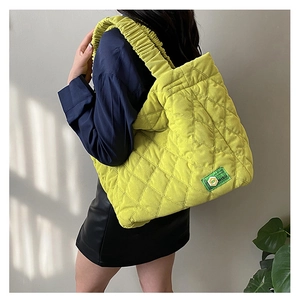 Quilted tote bag in neon yellow with large diamond texture and soft cloud straps