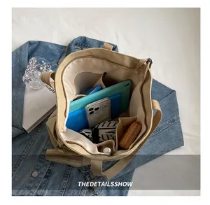 Top view showing the spacious interior of beige canvas tote with multiple compartments