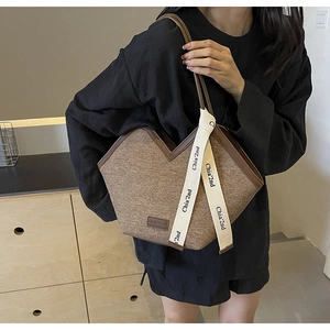 Détail du sac fourre-tout en tissu marron avec bordure en cuir et sangle tissée Chia'2nd