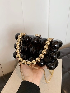 Elegant black beaded crossbody bag with a round handle and gold chain for women