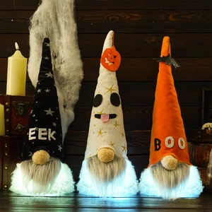 Three Halloween light-up gnomes with Boo and Eek text on dark wood background