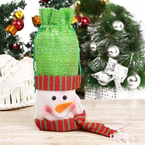 Christmas snowman drawstring gift bag with green sequins and plush material on wooden table