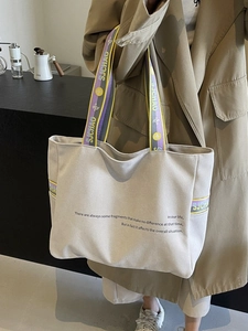 Minimalist canvas tote bag with contrast webbing handles and casual style for women