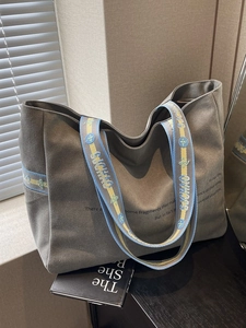 Minimalist grey canvas tote bag with large capacity and blue yellow embroidered strap