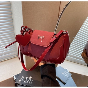 Dettaglio borsa a tracolla rossa con patchwork in pelle e fiocco argento