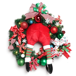 Christmas wreath with Santa legs, ornaments and warm LED lights on a white background