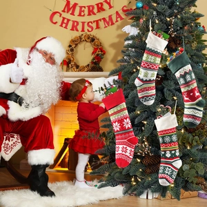 Set of four knitted Christmas stockings with reindeer and snowflake patterns for decor