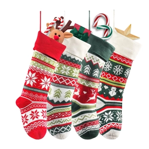 Set of four knitted Christmas stockings with reindeer and snowflake festive patterns
