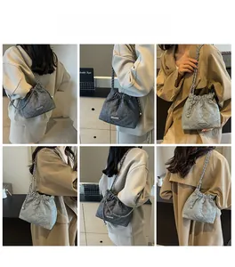 Deep grey quilted bucket bag with chain strap shown in various poses and angles