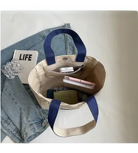 Detailed top view of large canvas tote bag interior with zip pocket and daily essentials