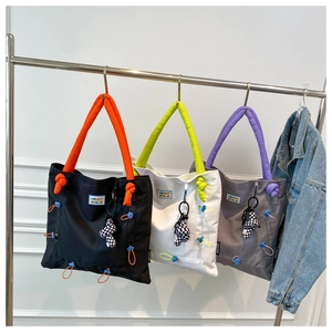 Nylon tote bags with colored padded handles and checkered mushroom charm detail