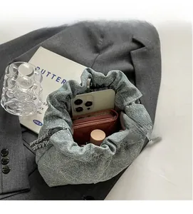 Interior view of denim bucket bag showing large capacity for essentials like phone and wallet