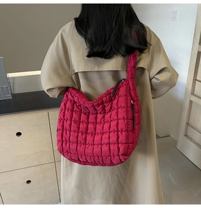 Detail of rose red quilted tote bag with diamond pattern and soft bubble texture