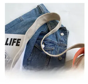 Detail of canvas tote with woven orange straps and zipper on top of life magazine