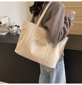 Detailed close-up of large canvas tote bag with 2024 p.b market letter printing