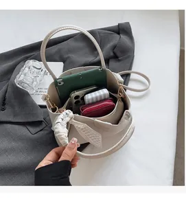 Detail of off-white bucket bag interior showing spacious storage for tablet and essentials