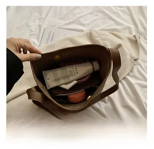 Interior view showing the large capacity of the brown lychee leather bucket bag