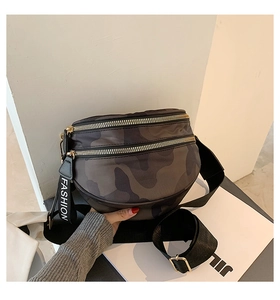 Close-up of camouflage saddle bag with double zipper and FASHION woven strap detail