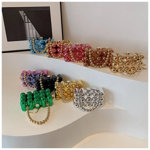 Detail of colorful metallic beaded evening handbags with acrylic chain handles