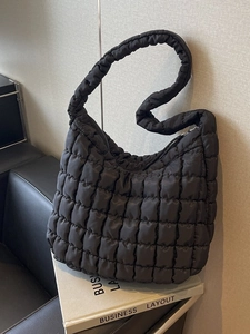Quilted black puffer tote bag with a soft cloud texture for women shoulder carrying