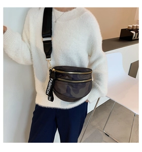 Model wearing a camouflage crossbody chest bag with double gold zippers and wide strap