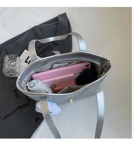 Detailed interior of a large silver tote bag showing its spacious capacity for daily items