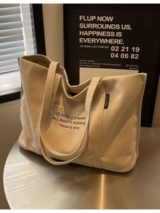 Minimalist beige canvas tote bag with letter print and large capacity for daily commuting