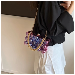 Detail of purple and blue gradient acrylic sphere evening bag with gold bead handle